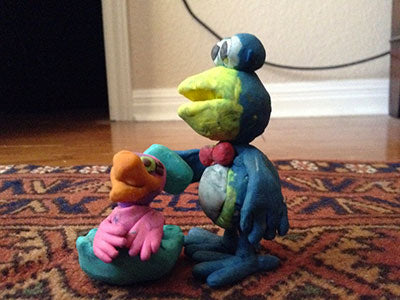 Cro bathing baby bird. Clay sculptures with doll furniture.