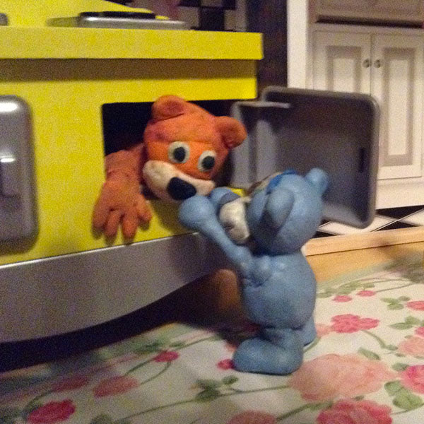Helping bear out of oven, clay figures